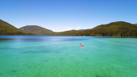 aerial view of woman kayaking on a lake 4k