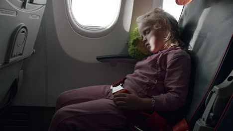 little traveller sleeping in flying plane