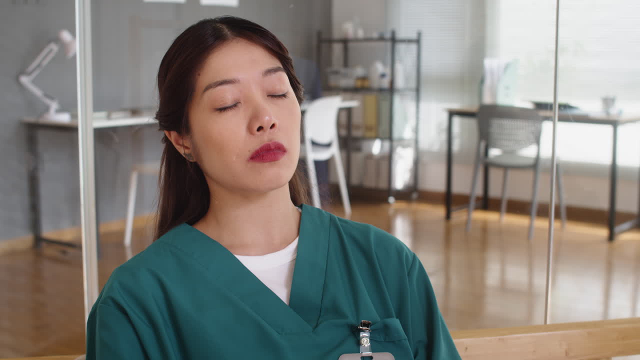 Sleepy Female Doctor Yawning on Sofa at Hospital