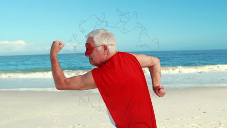 animation of networks of connections over happy senior man in red superhero cape exercising on beach