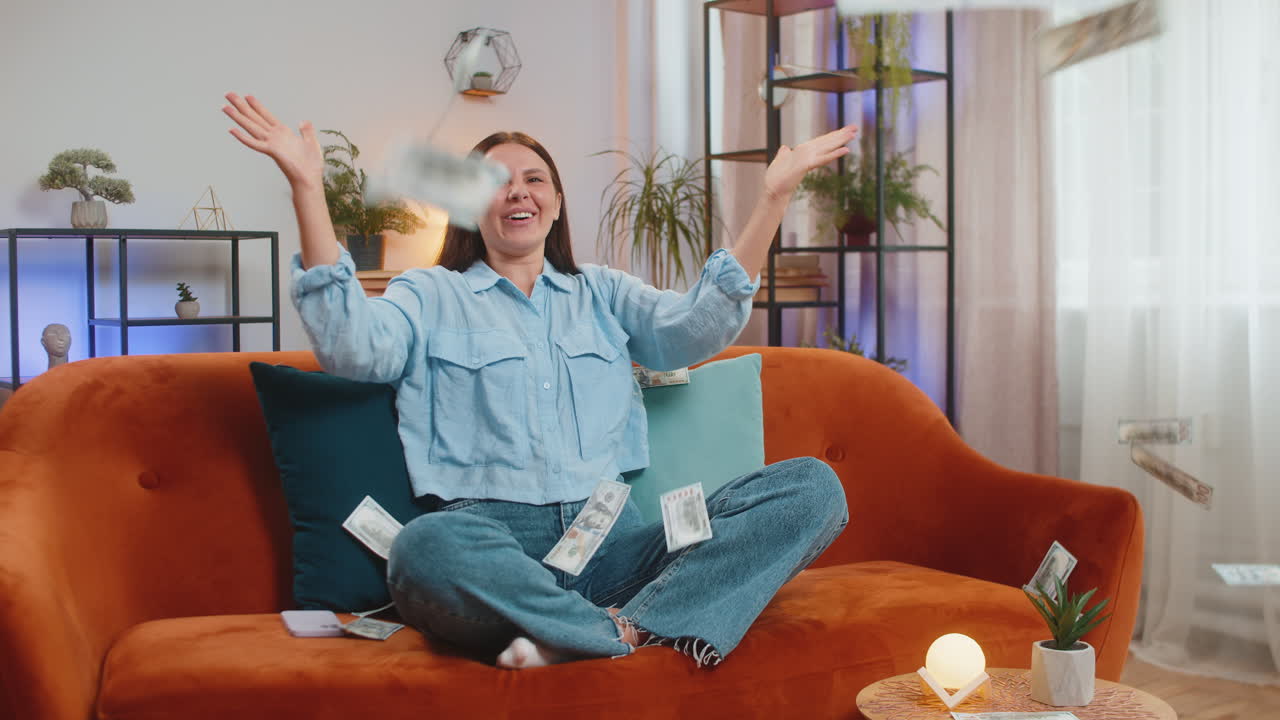 Money cash dollar rain falling on woman celebrating success winning good news lottery jackpot luck