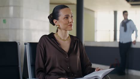 woman reading in airport lounge