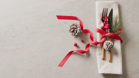 Video-of-christmas-place-setting-with-cutlery-and-copy-space-on-grey-background