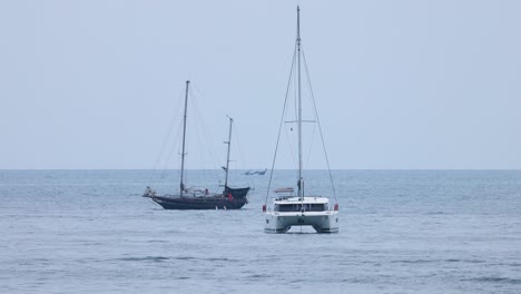 two yachts moving parallel in calm sea