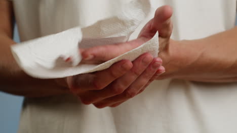 person drying hands with paper towel