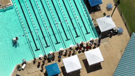 open air swimming tournament with gathered audience during sunny summer day