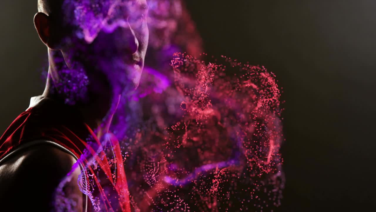 Animation of red particles over african american male basketball player