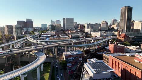 aerial rise up to reveal busy roadway and richmond virginia skyline