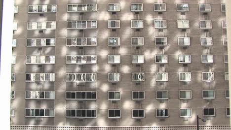 A Large Apartment Or Hotel Exterior Provides An Interesting Background Pattern From Reflected Sunlight And The Regular Placement Of Its Windows