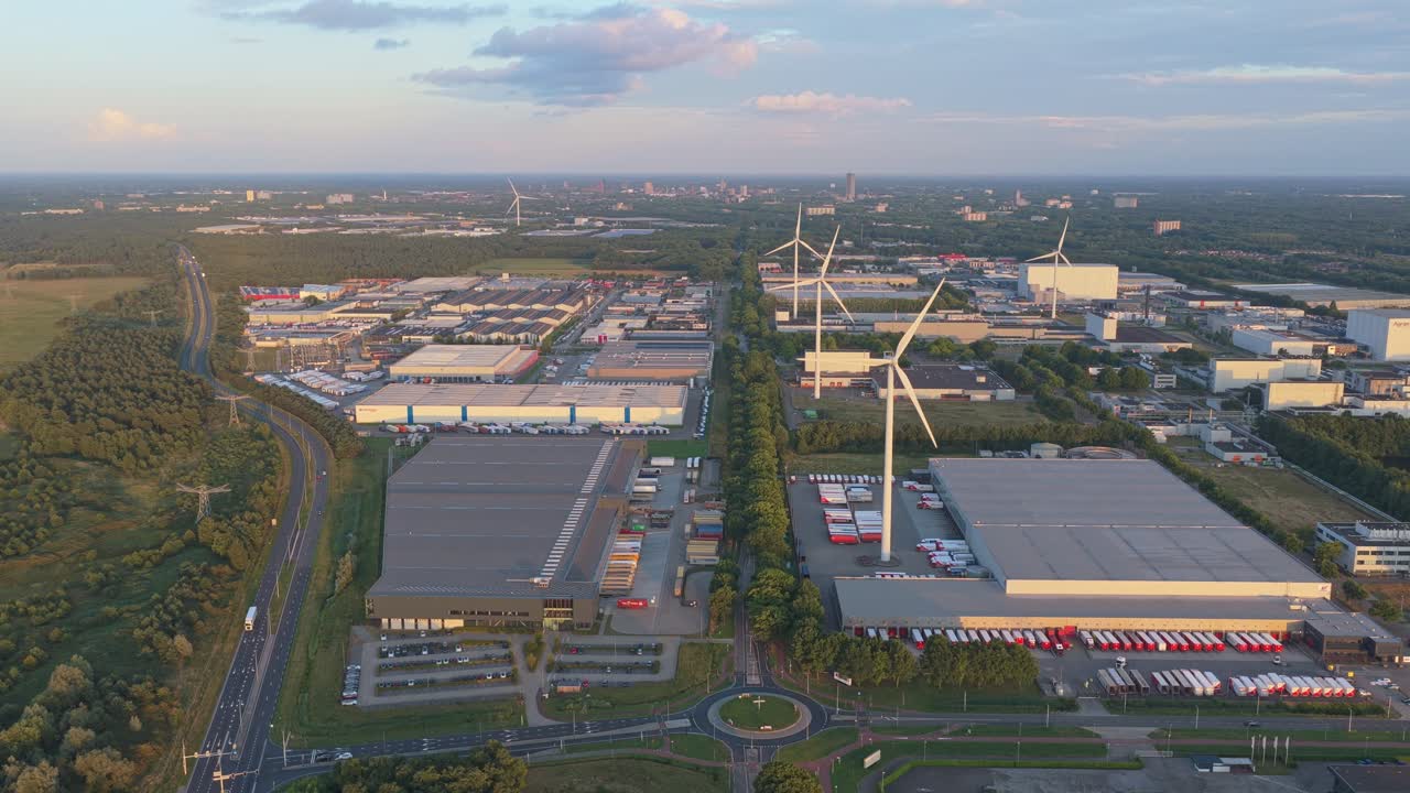 Logistics centers in Netherlands, solar panel roofs and turbines at sunset