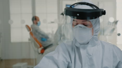 close up of dentistry nurse with hazmat suit working on oral care