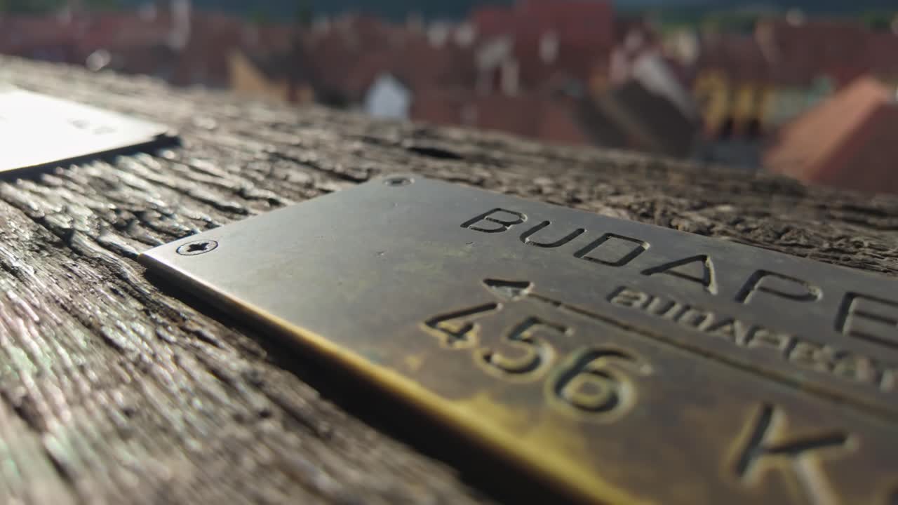 Close-up of a brass plate indicating the distance to Budapest, Hungary from the Clock Tower in Sighișoara, Romania