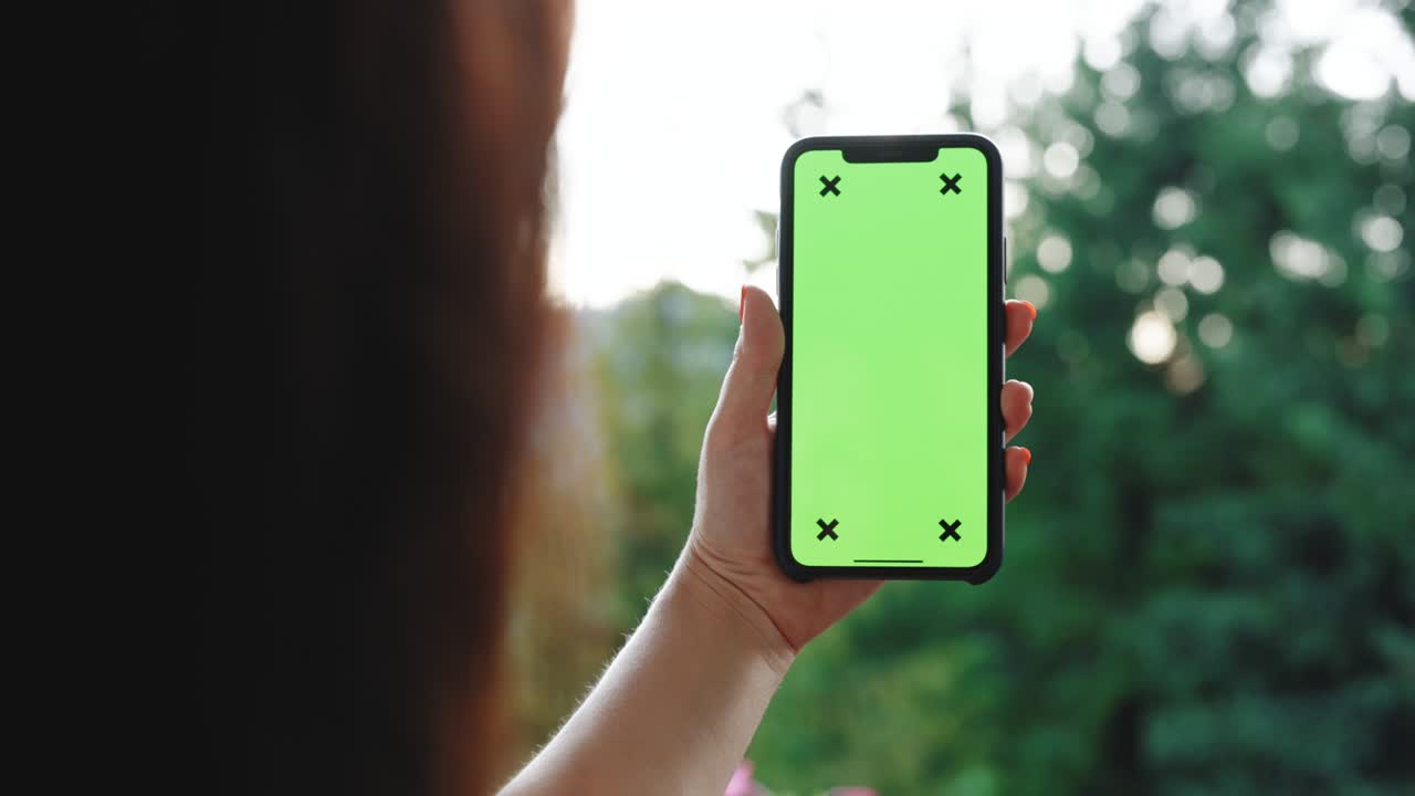 fotografía de cerca de una mujer usando un teléfono inteligente con pantalla verde de clave de croma, desplazándose a través de las redes sociales o compras en línea. tecnología, conexión, internet, concepto de comunicaciones