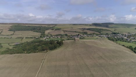 Forward-tracking-aerial-high-above-the-dorset-coast-heading-towards-the-Chapel-of-St-Catherine's-near-Weymouth,-Dorset