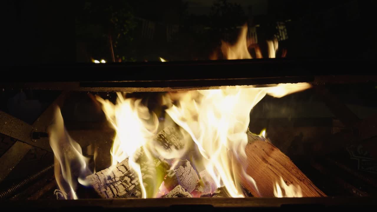 The firewood crackles as it burns with bright flames, perfect for grilling