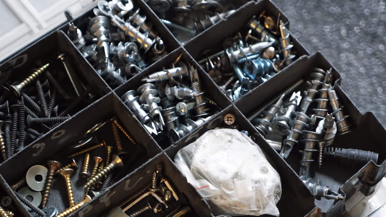 A box with multiple different screws and instruments