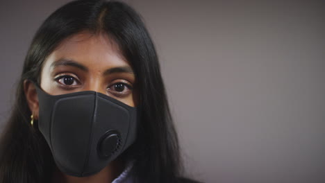 young woman wearing face mask pull focus copy space