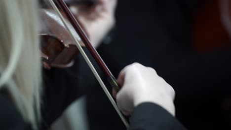 classical music played by female violinist on symphony orchestra