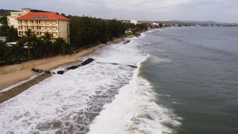 an aerial shot of geotubes protecting beach from sand erosion rising sea level