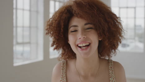 portrait of lively young mixed race woman smiling cheerful making faces enjoying happy independent lifestyle female student excited in new apartment