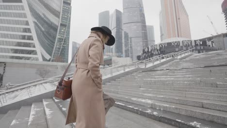 woman walking down stairs in a city