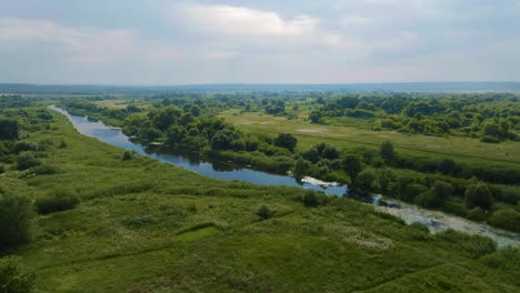 aerial view of a river winding through a lush green landscape