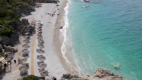 spectacular sea view from above as people sunbathe on the beach