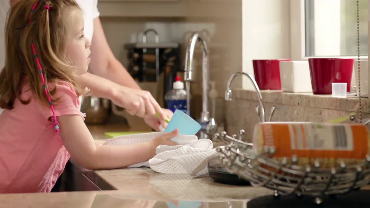 Mother and daughter washing up
