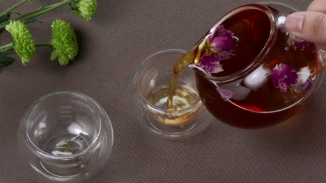 pouring rose tea into glass cups