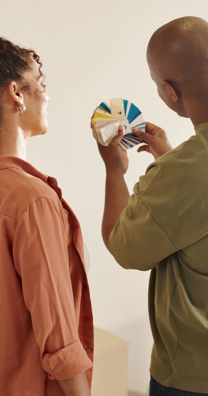 Couple Choosing Paint Colors from a Swatch Fan