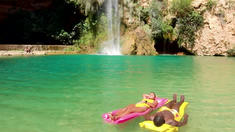 Diverse-couple-chilling-on-floats