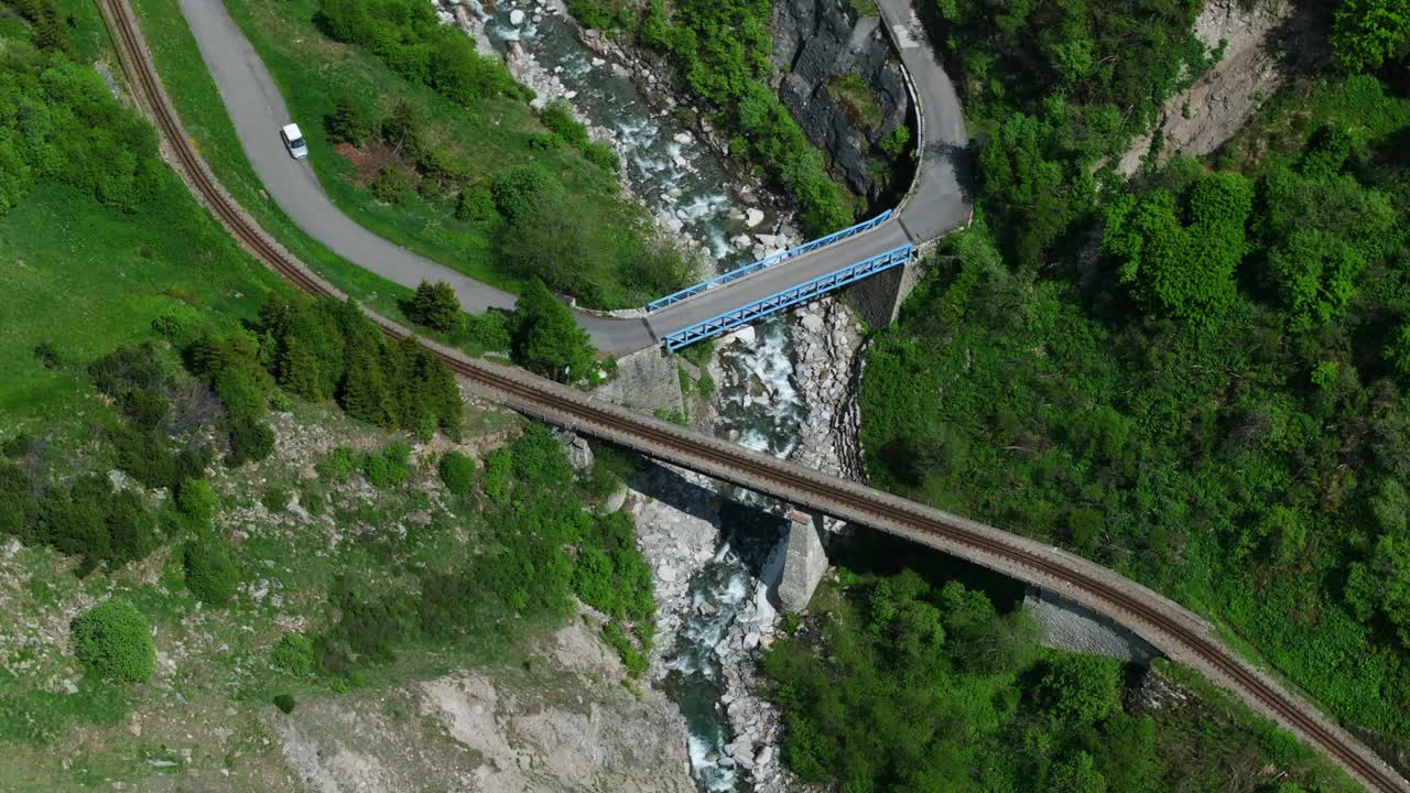 Bird's Eye View Over Railroad And Bridge In The Alps, Furkapass Of Switzerland - drone shot