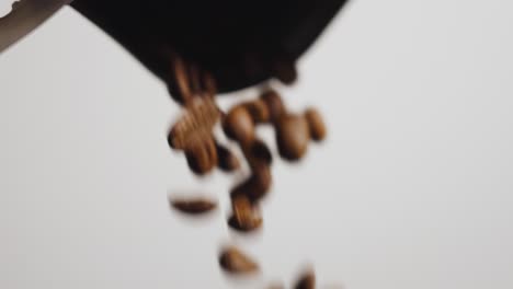 coffee beans pouring out of a bag in slow ecu