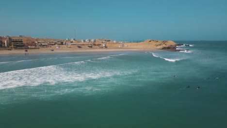 surfer riding ocean wave in lobitos, peru on a sunny summer day