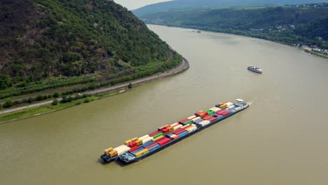 Industrial-barge-Freighter-Ship-transporting-Cargo-Container-cruising-river-Rhine-loop-at-Bopparder-Hamm,-Germany