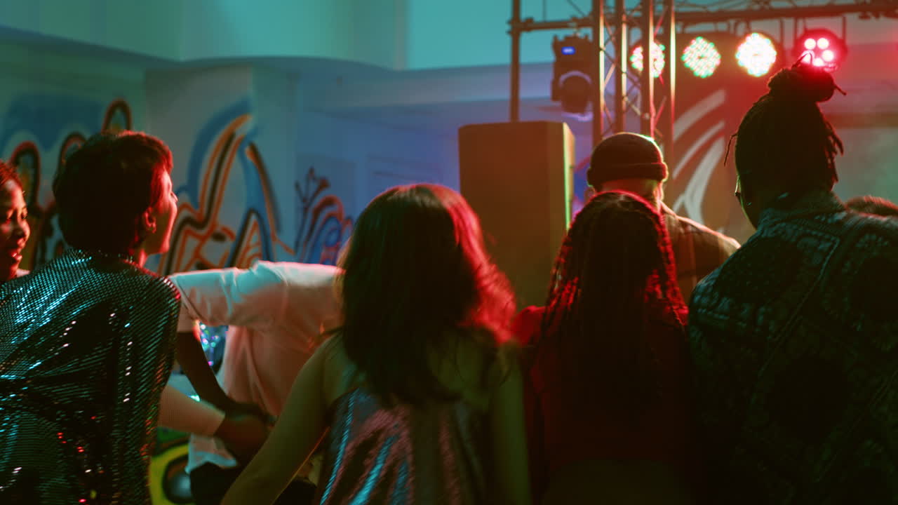 People dancing and enjoying a party with music and lights