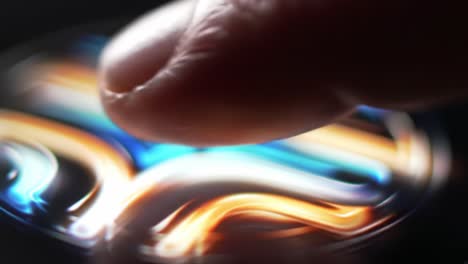 a close-up of a finger gliding over an interactive surface, creating dynamic patterns of color and light, showcasing the intersection of technology and touch