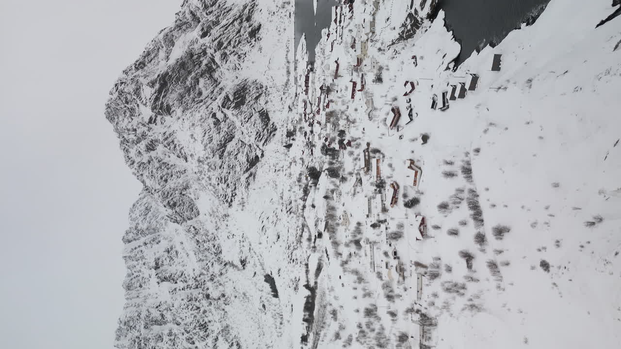 노르웨이 북부 로포텐 섬 에 있는 눈이 내린 마을 의 수직적 인 모습