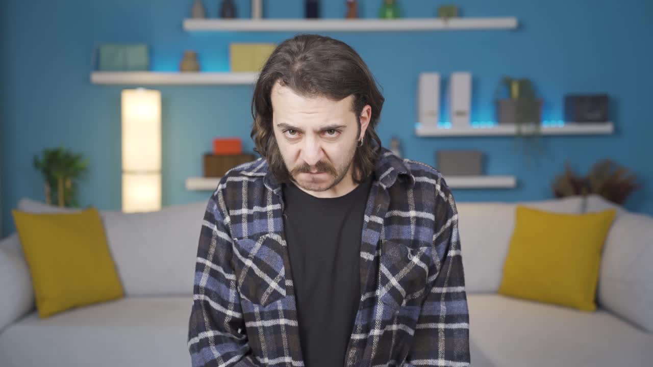 Nervous man looking at camera and biting his nails.  He's stressed. Gestures.