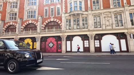 vehicles and pedestrians on a london street