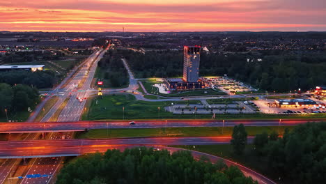 cars go by the highways lit by the lights at sunset. aerial perspective on the beautiful countryside in the netherlands.