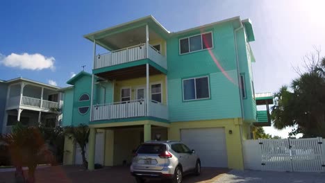 a slow moving shot passing several colorful vacation homes on anna maria island, florida