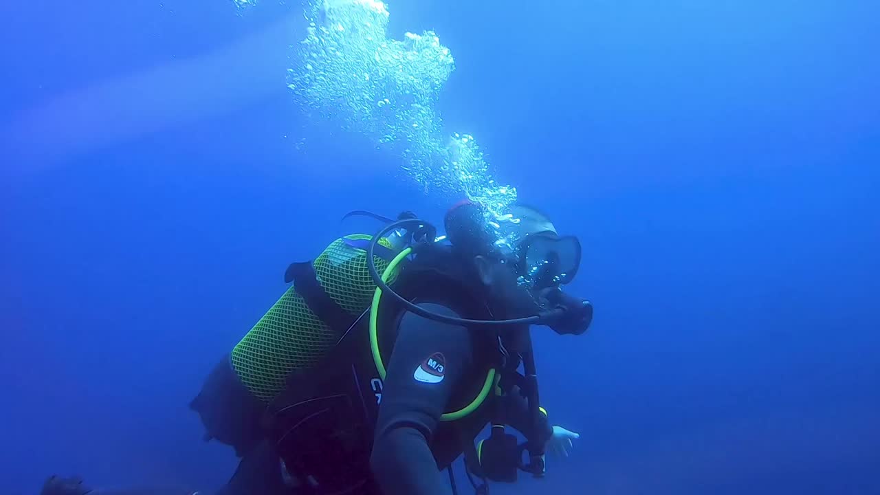 Diver Swims Underwater In The Blue Bay Of Fornells In Menorca, Spain. medium shot