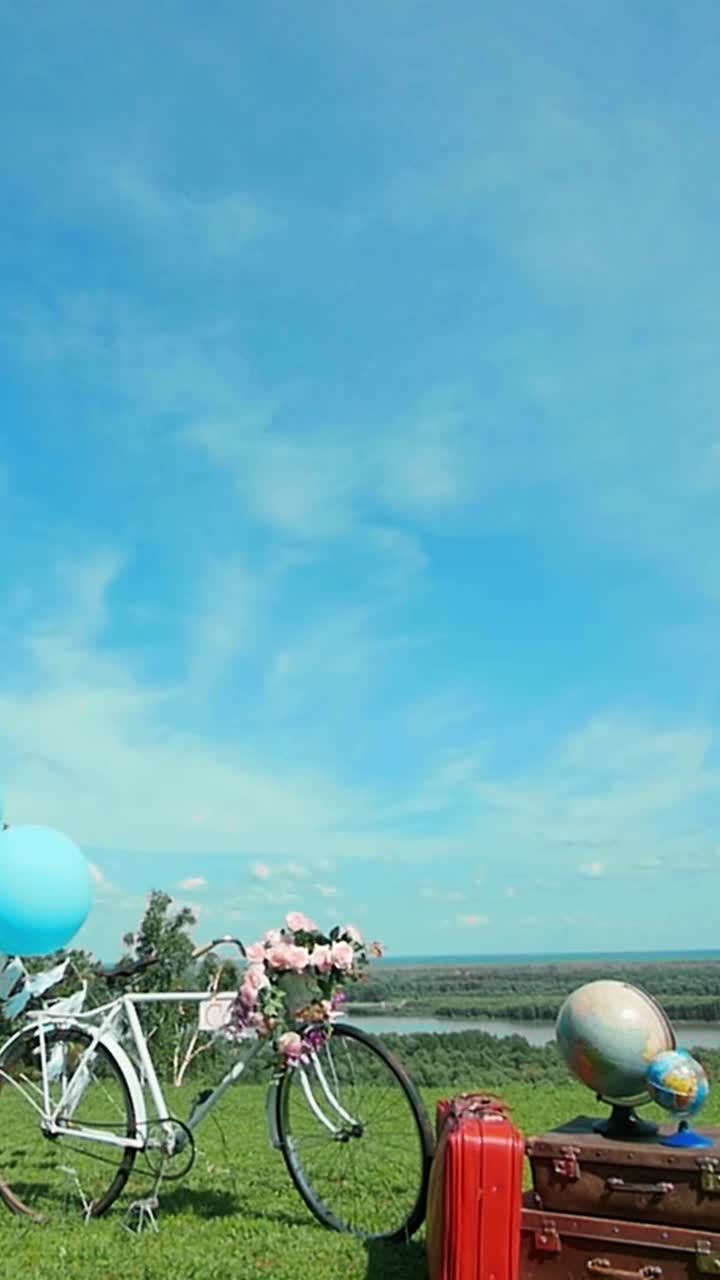 Vintage Bicycle with Travel Accessories in a Scenic Landscape