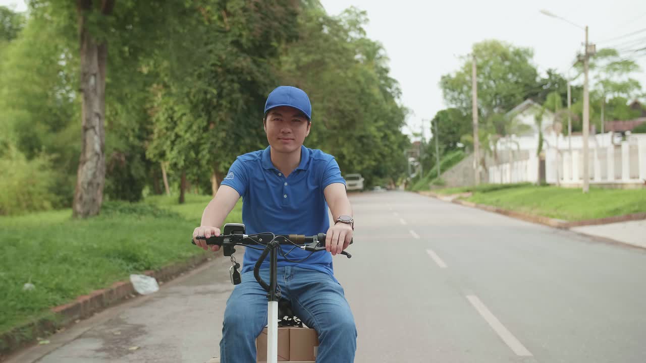 Delivery Man Courier Rides A Electric Scooter On The Road To Deliver Orders And Packages For Customers