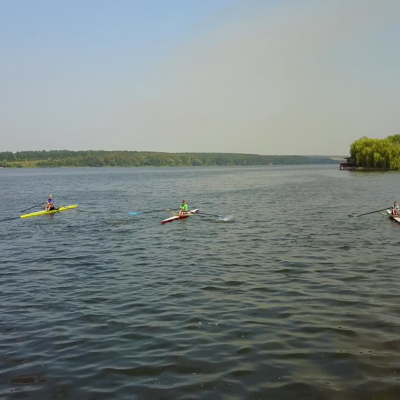 Training Athlete In Kayak. Training of small sportsmen rowers on a kayak on the river