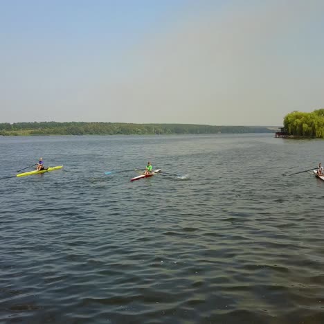 training athlete in kayak. training of small sportsmen rowers on a kayak on the river