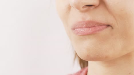 Woman-eating-chocolate-with-heart-in-close-up.-Eating-chocolate.