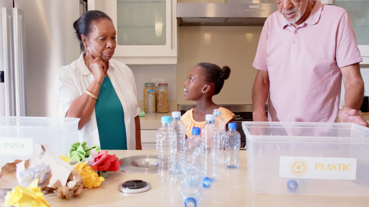 In kitchen, child sorting recyclables with diverse grandparents, focusing on environment, at home