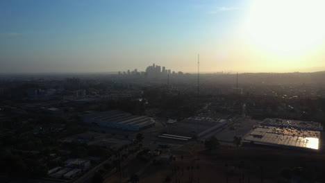 drone aerial descend with the downtown los angeles skyline in the background at sunset, california, usa